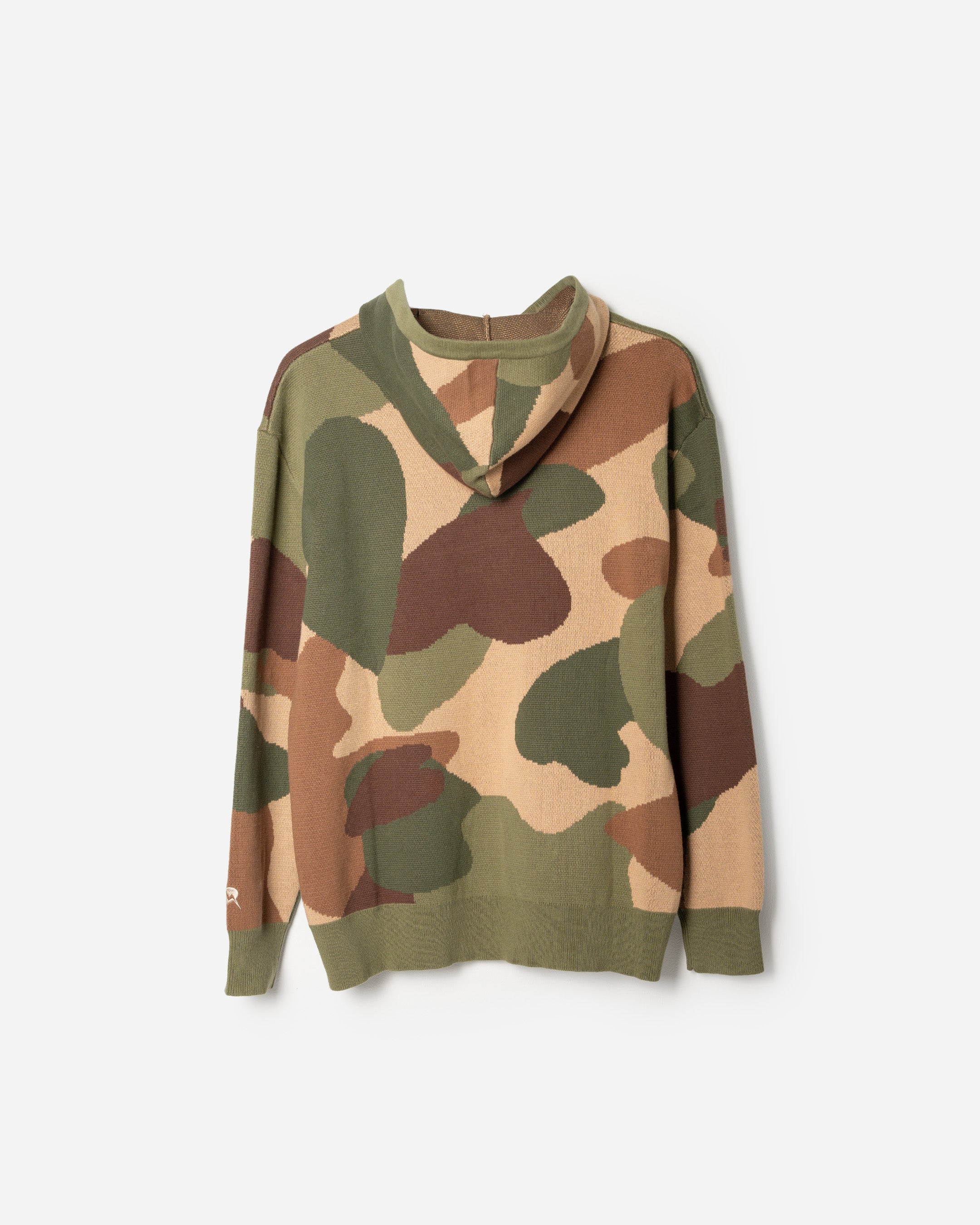 Camouflage-patterned sweater on a white background